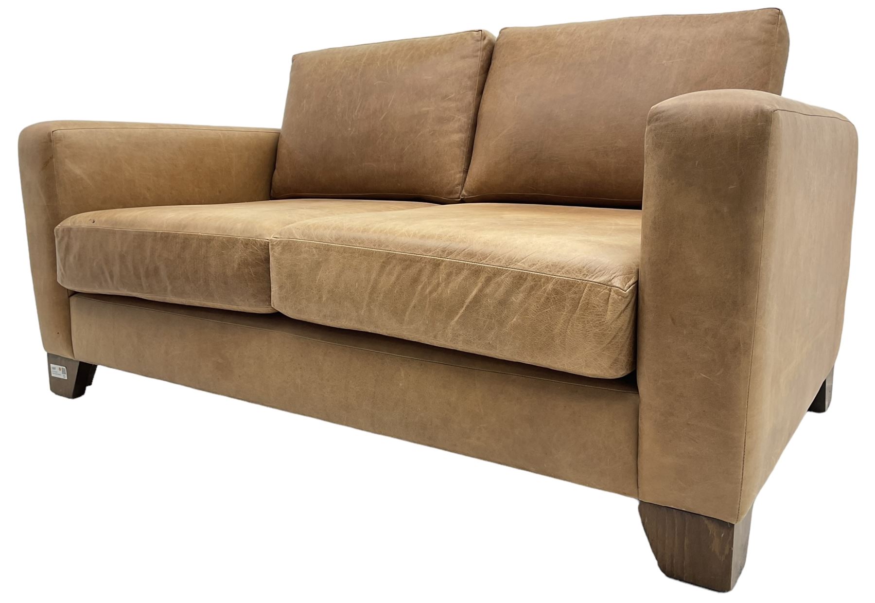 20th century two seat sofa, upholstered in tan leather with loose back and seat cushions, on