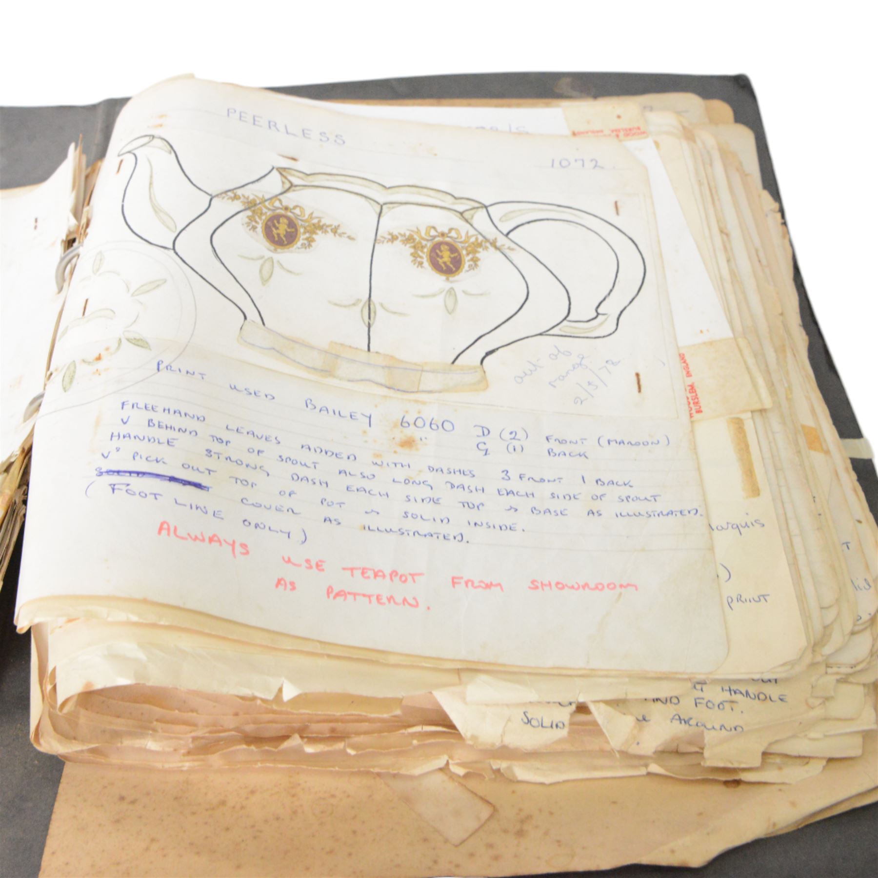 Wood & Sons Ltd Burslem pattern book, late 20th century, designs in colour and black and white, all mounted onto square leaves, leaves annotated with decorating notes, some cancellations noted boldly over the design, collected as one in a ring binder, factory labels to upper-cover, folio 44.5 x 36cm