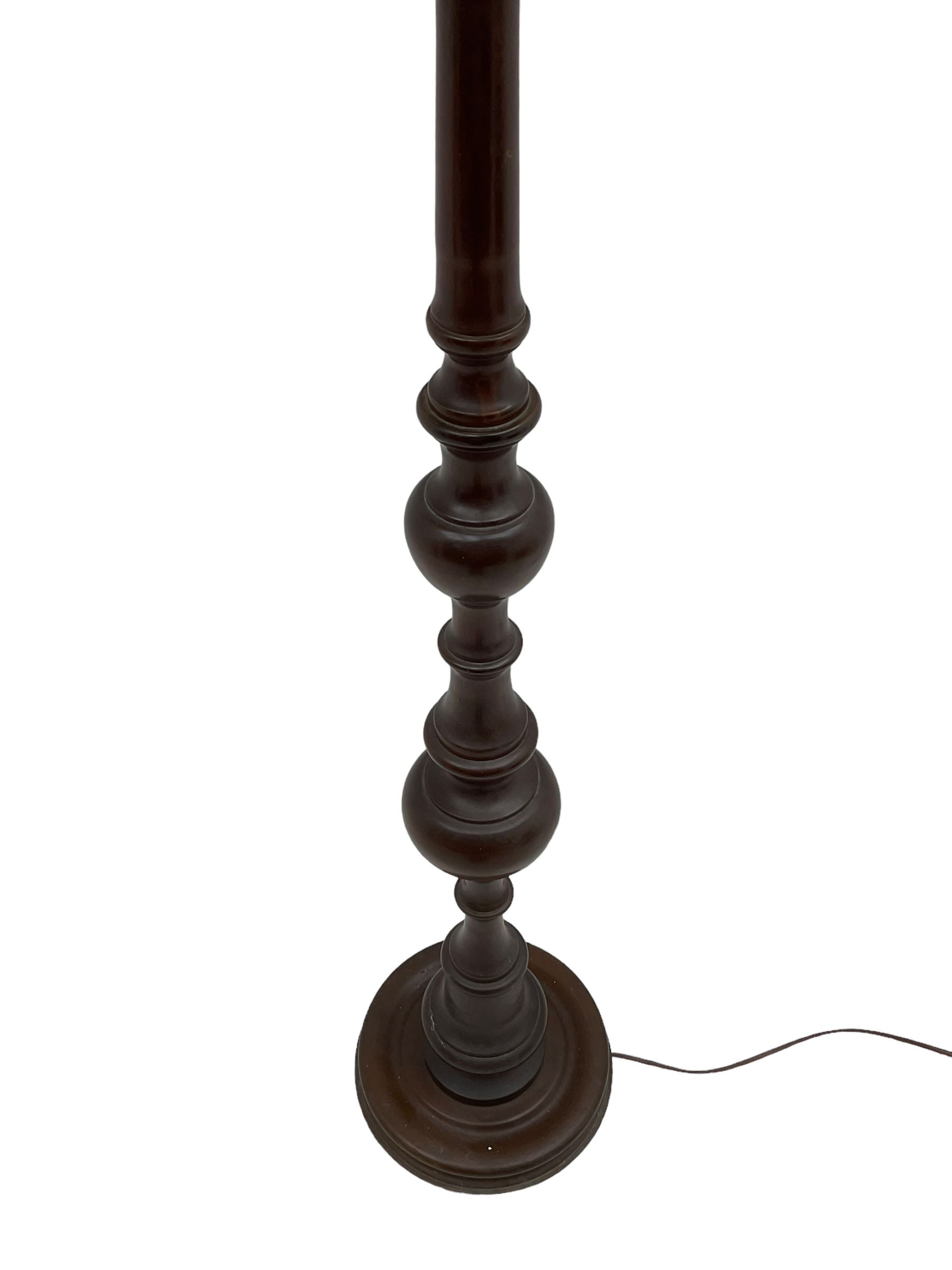 20th century walnut standard lamp, turned column on circular base, with shade 