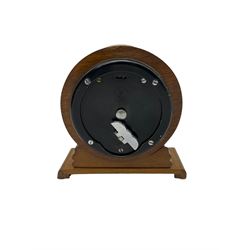 A late 19th century French 8-day carriage clock in a corniche style case with an alarm, white enamel dial with Roman numerals, minute markers, steel moon hands and subsidiary alarm setting dial, movement with a later replacement lever platform escapement. With key. H18 D8 W10
With a mid-20th century English mantle clock in a 4.5” circular wooden case with a shaped and carved plinth, silvered dial with gilt baton hands and hour markers, spring driven movement by “Elliot” integrally wound and set from the rear.

