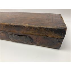 Leather shotgun case, the red baize lined interior with the trade labels of Westley Richards & Co., London, a brass plaque inscribed 'T Nevin, Mirfield, Yorkshire' to cover, with key, case to fit barrel 76cm (30 inches)  
