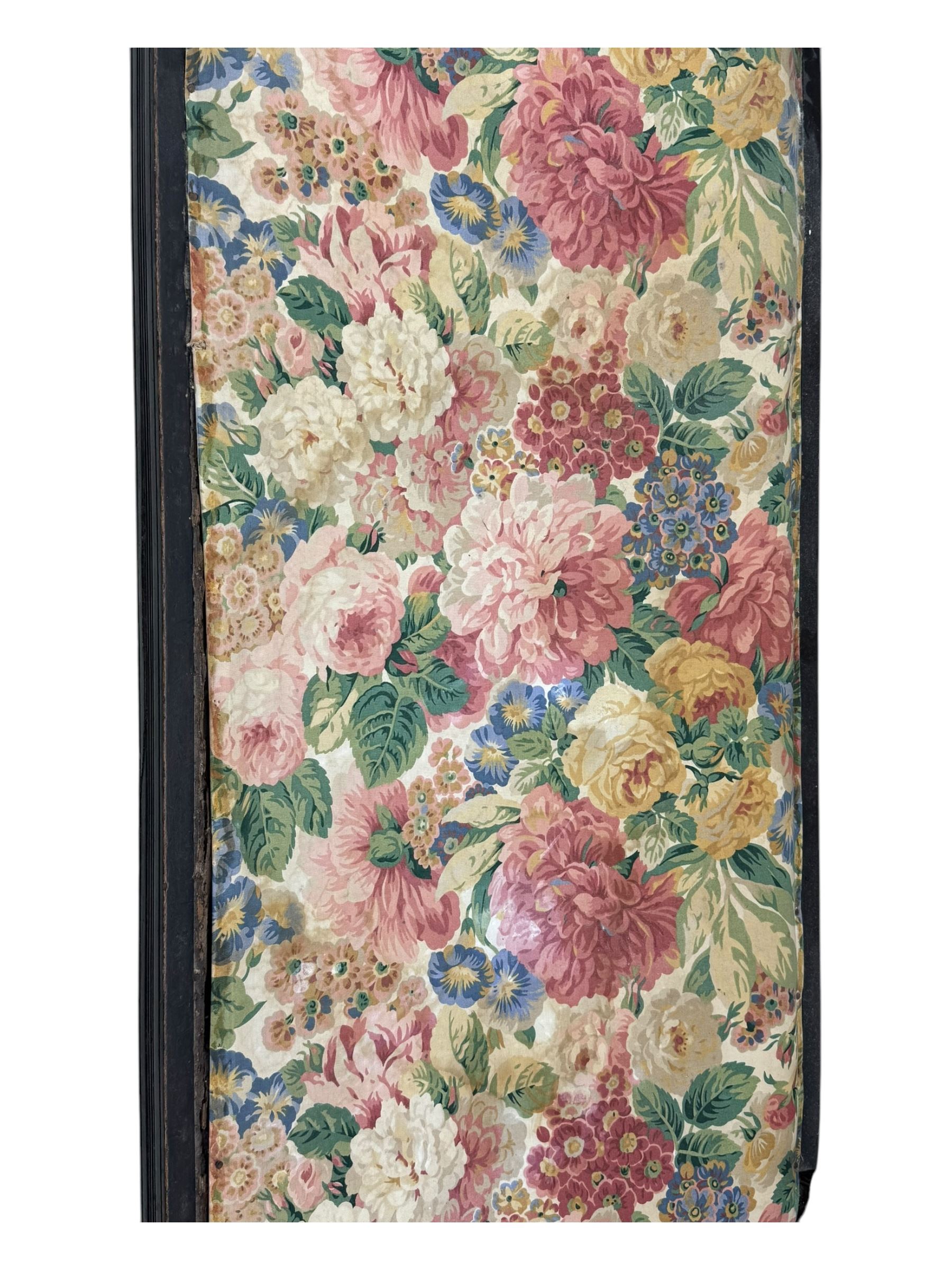 Edwardian mahogany three seater settee, upholstered in floral fabric. Shield back with padded armrests and cabriole legs  