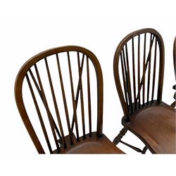 Set four ash stick and hoop back Windsor chairs, dished saddle seats on turned supports joined by crinoline stretchers