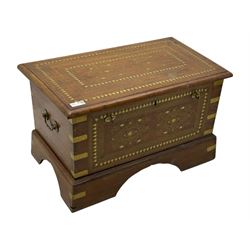 Zanzibar chest, early 20th century, of hardwood construction with brass inlaid foliate and geometric decoration to the lid, fitted interior of multiple carved compartments, with brass strapwork, side handles, and shaped bracket feet