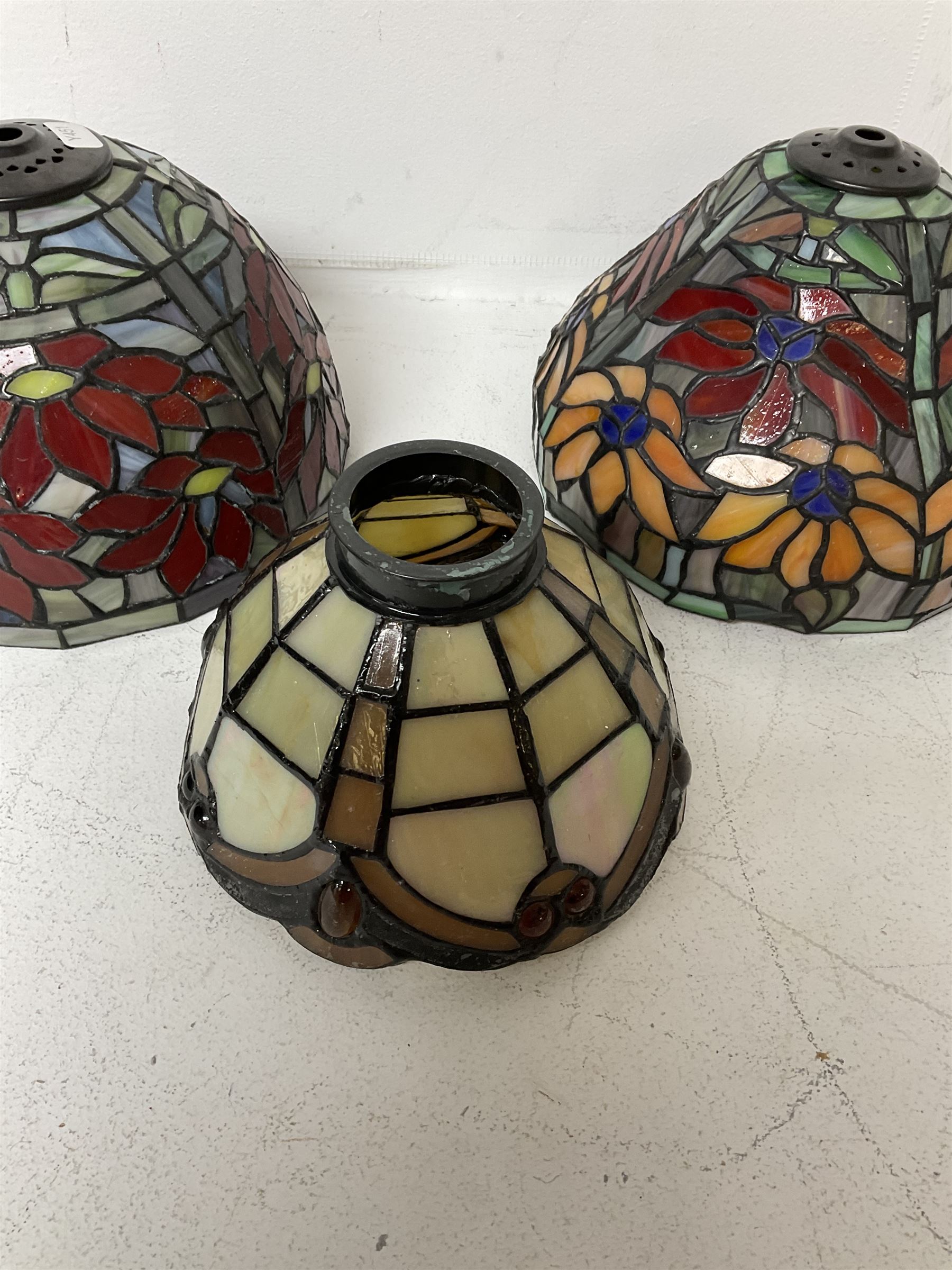 Three Tiffany style lamp shades, each with multicoloured floral decoration, largest D20.5cm