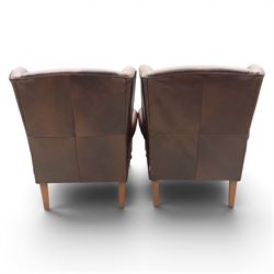 Marks & Spencer - Pair of brown leather wing back chairs, raised on light stained supports with castors