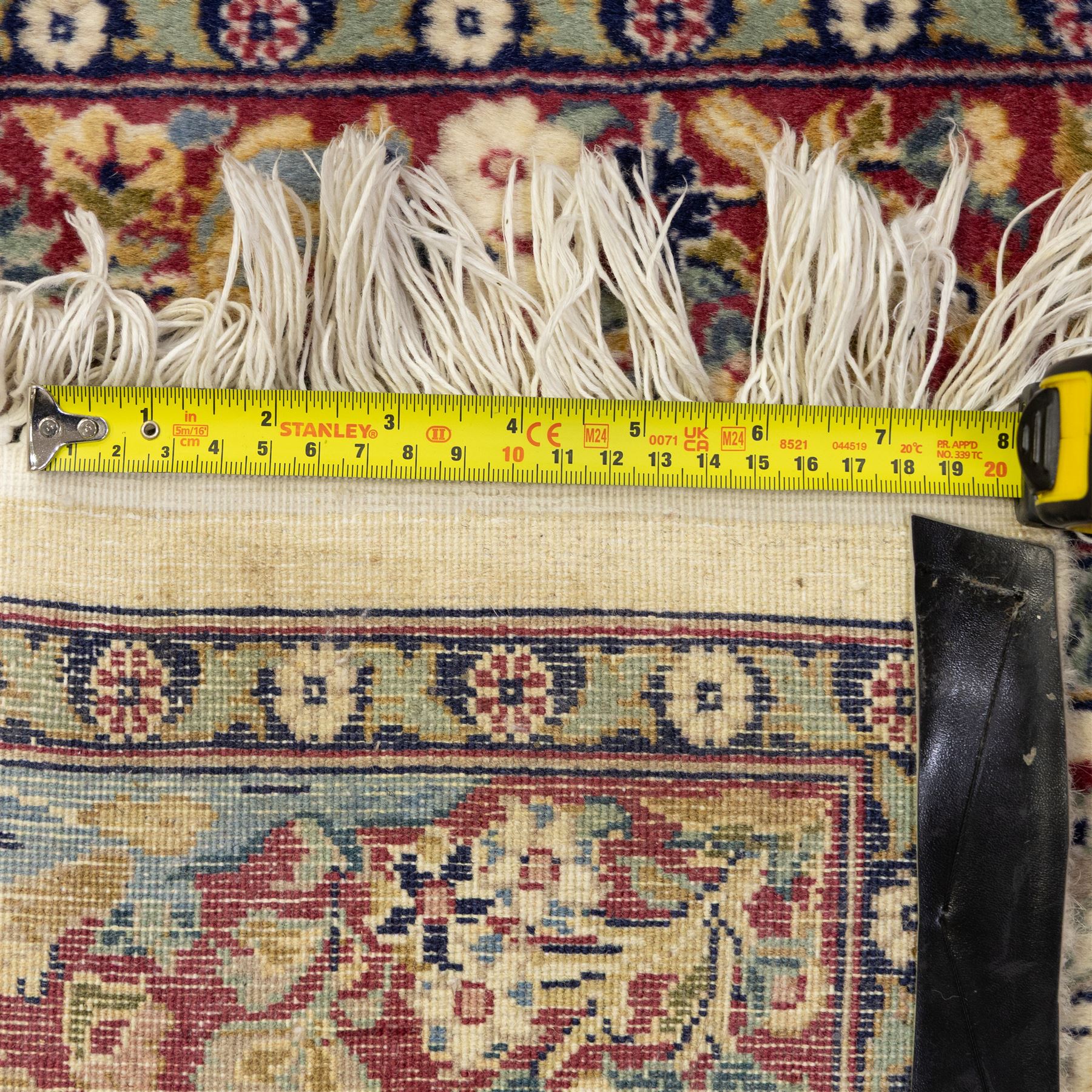 Two Central Persian rugs, ivory ground with a symmetrical foliate and floral design around a shaped cartouche medallion with a red floral and bird motif border with contrasting guard stripes, 142x76cm, Central Persian Kashan rug, crimson central field with a floral and foliate design with a stylized rosette medallion incorporating palmettes and scrolling vine work, enclosed by a dark navy border and multiple guard stripes, 117x68cm, (2)