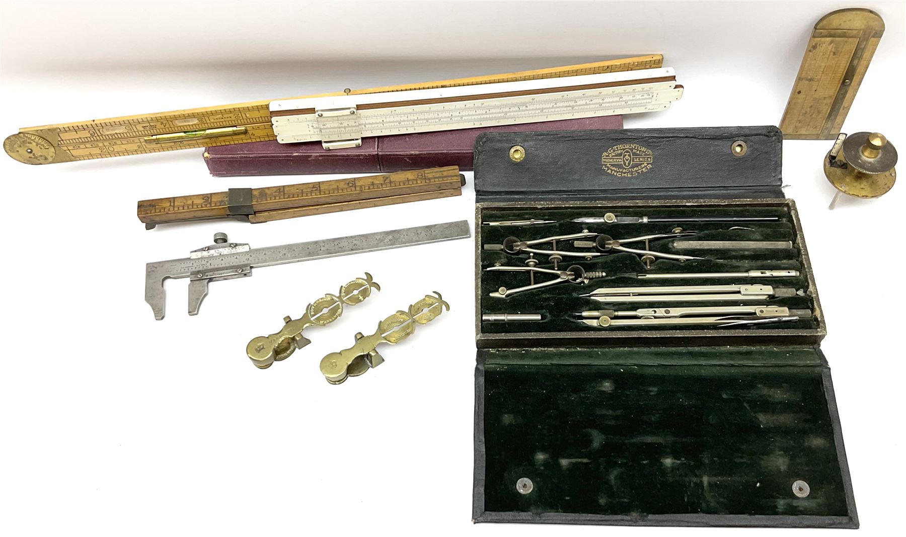 Two Victorian brass sovereign scales, one marked 'Harrison' L10cm; cased set of drawing instruments by G. Thornton Limited Manchester; Chesterman No.770/1 steel vernier caliper; two boxwood rulers; cased slide rule; brass and boxwood rope/wire gauge etc