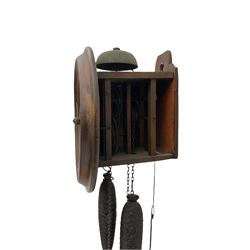 A German 30-hour chain driven wooden framed Postman’s Alarm clock, sounding on a bell, with internal wooden movement plates and brass train wheels, 7” chapter ring with roman numerals, minute track and half hour markers, with steel hands (minute hand a replacement) and alarm setting disc to the centre, with a 10-1/2” oak bezel and hinged side viewing doors. With weights and pendulum.




