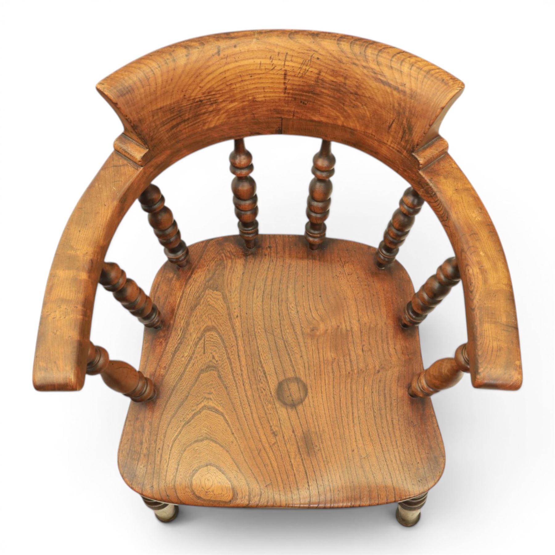 Early 20th century elm smoker's bow or captain's chair, elm dished seat raised on turned supports