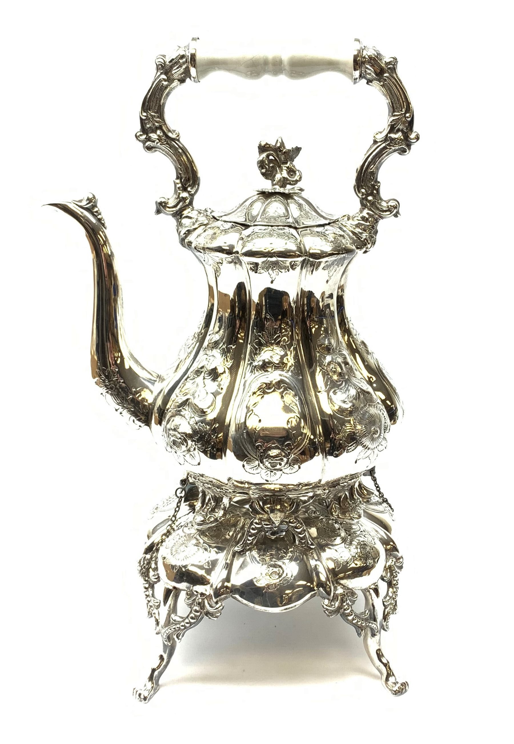 A Victorian style silver plated teapot on stand, each with foliate