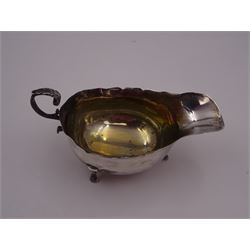 Edwardian silver sauce boat, of typical form, with shaped rim and acanthus capped flying scroll handle, upon three paw feet, hallmarked Wilson & Gill, London 1903, H7.4cm