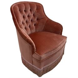 Victorian style upholstered tub-shaped bedroom chair, upholstered in buttoned pink fabric, on turned feet