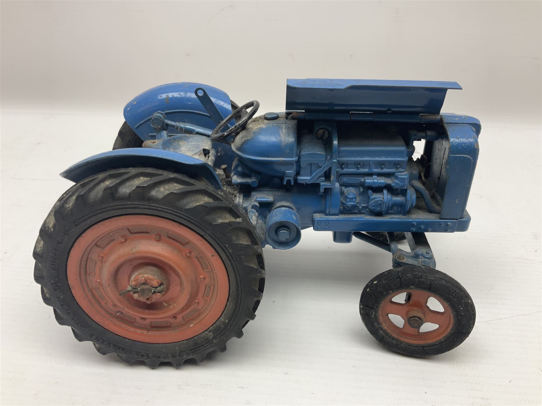 Chad Valley - two unboxed and playworn large scale Fordson tractors - No.9235 Fordson Major Tractor, dark blue diecast body, orange wheels, crank handle clockwork mechanism and 'Firestone' rubber tyres; and No.M59 New Fordson Major Tractor, blue diecast body, tinplate hinged bonnet, orange wheels and clockwork motor contained in rear wheel hub (2)