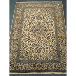  Kashan beige and blue ground rug, central medallion, repeating border, 293cm x 203cm  