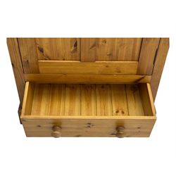 Pine single wardrobe, enclosed by single panelled door, fitted with single drawer, on plinth base 