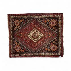 Southwestern Persian Qashqai rug, central diamond medallion with hooked motifs flanked by four corner medallions on a rich red madder field with dark brown ground of stylized floral and animal motifs, and ivory border with alternating floral palmettes and a red main  border with a meandering vine pattern 
