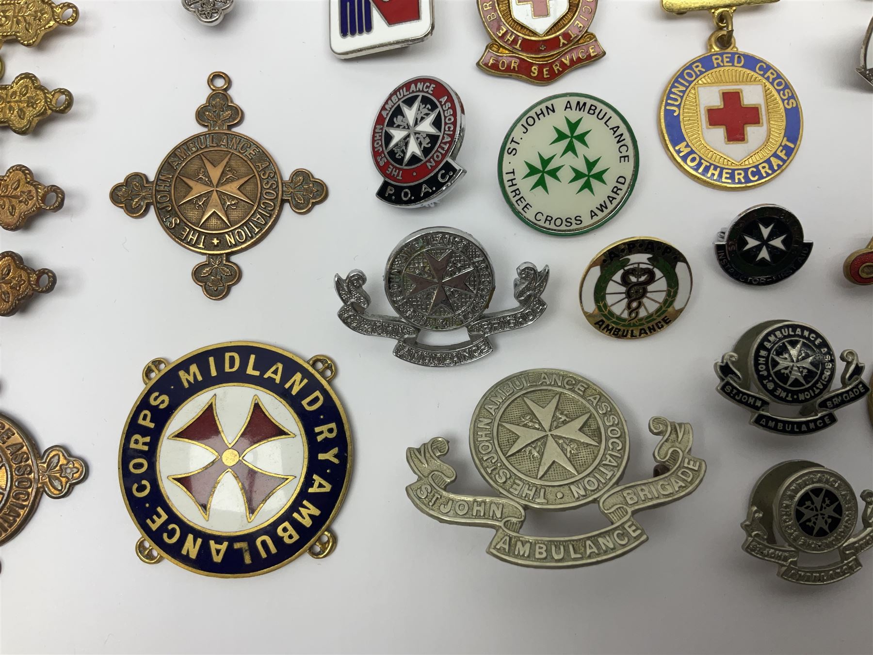 Collection of St John Ambulance enamel and metal badges, together with Red Cross medals and badges