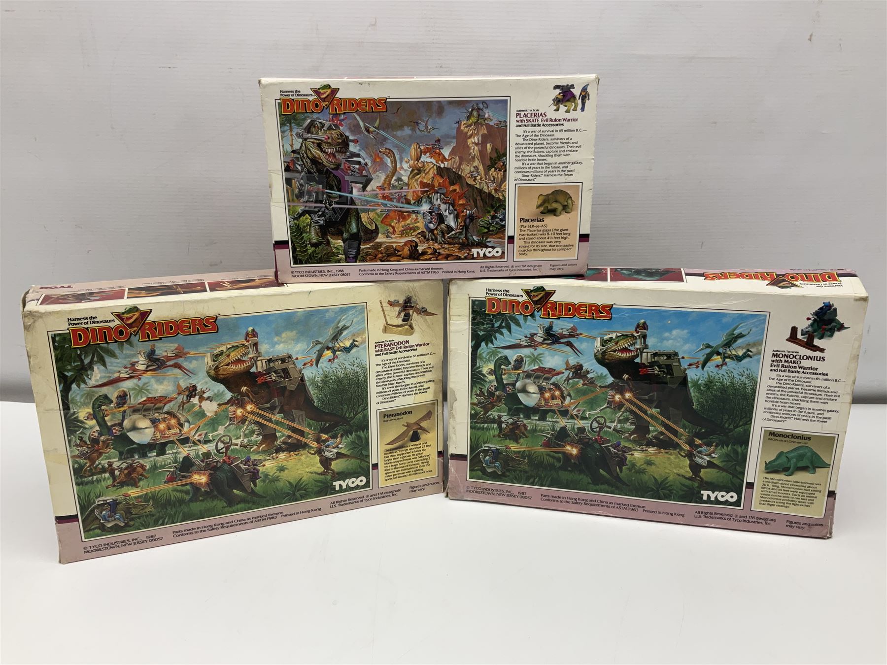 Three Tyco Dino-Riders by Action GT playsets - Pteranodon with Rasp Evil Rulon Warrior; Monoclonius with Mako Evil Rulon Warrior; and Placerias with Skate Evil Rulon Warrior; all boxed (3)