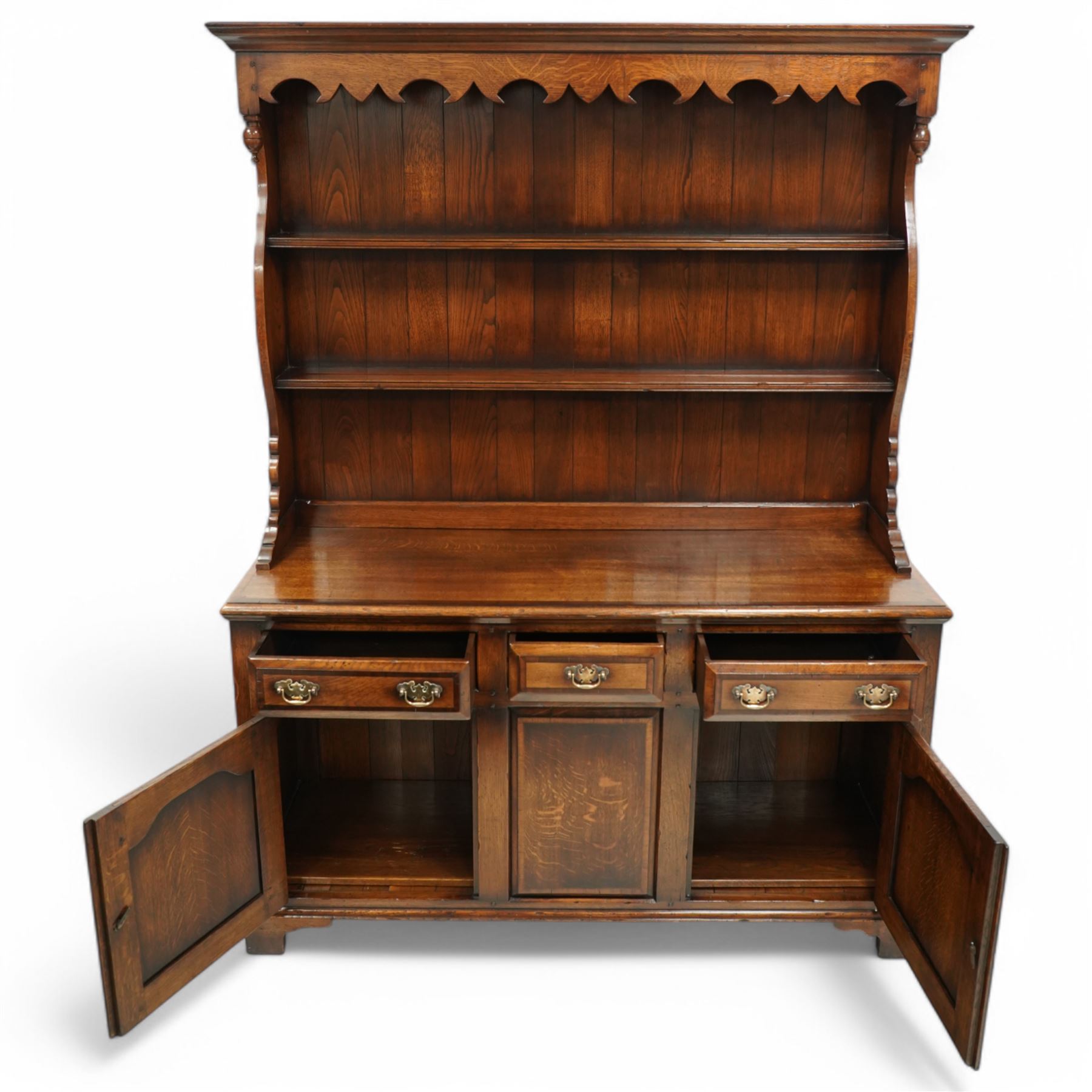 Gostins of Liverpool - Georgian design oak dresser, the two-tier rack with moulded cornice over shaped frieze and end supports, the dresser base with moulded rectangular top over tree drawers and two cupboards, panelled sides, on bracket feet