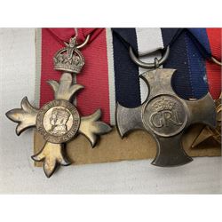 WW2 Royal Naval group of eight medals comprising OBE, hallmarked silver Distinguished Service Cross inscribed verso Lieut. J.R. McCluskie RNVR 1945, 1939-1945 Star, Atlantic Star, Africa Star, 1939-1945 War Medal, Defence Medal and Royal Naval Patrol Service Medal inscribed Lieutenant J.R. McCluskie Royal Naval Patrol Service; with seven original photographs of a sea battle 27th November 1940 against the Italian Fleet and another photographic postcard of Sir Stafford Cripps arriving on board one of the vessels.