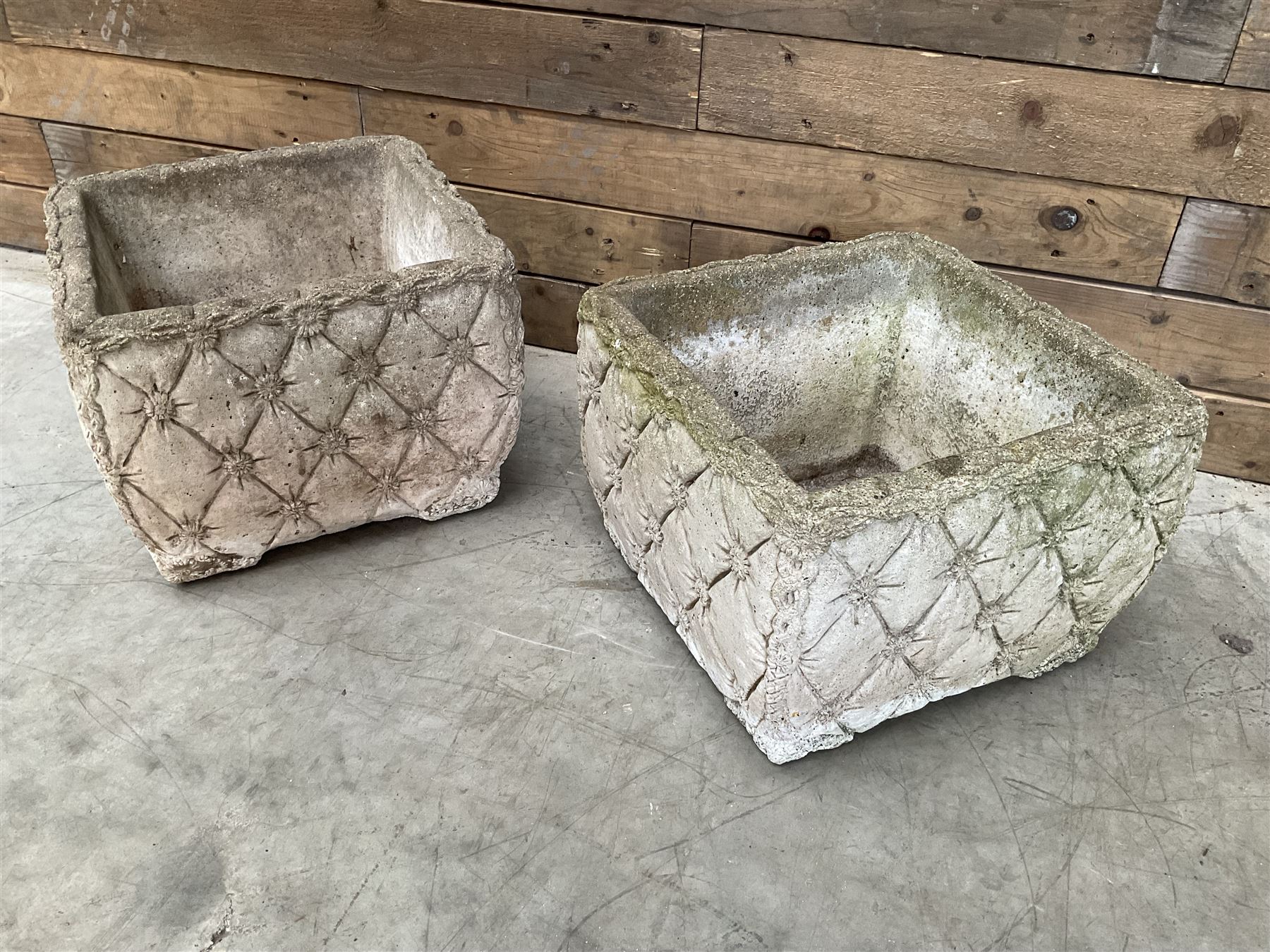 Pair of weathered cast stone square planters, daisy chain detail, one stamped
