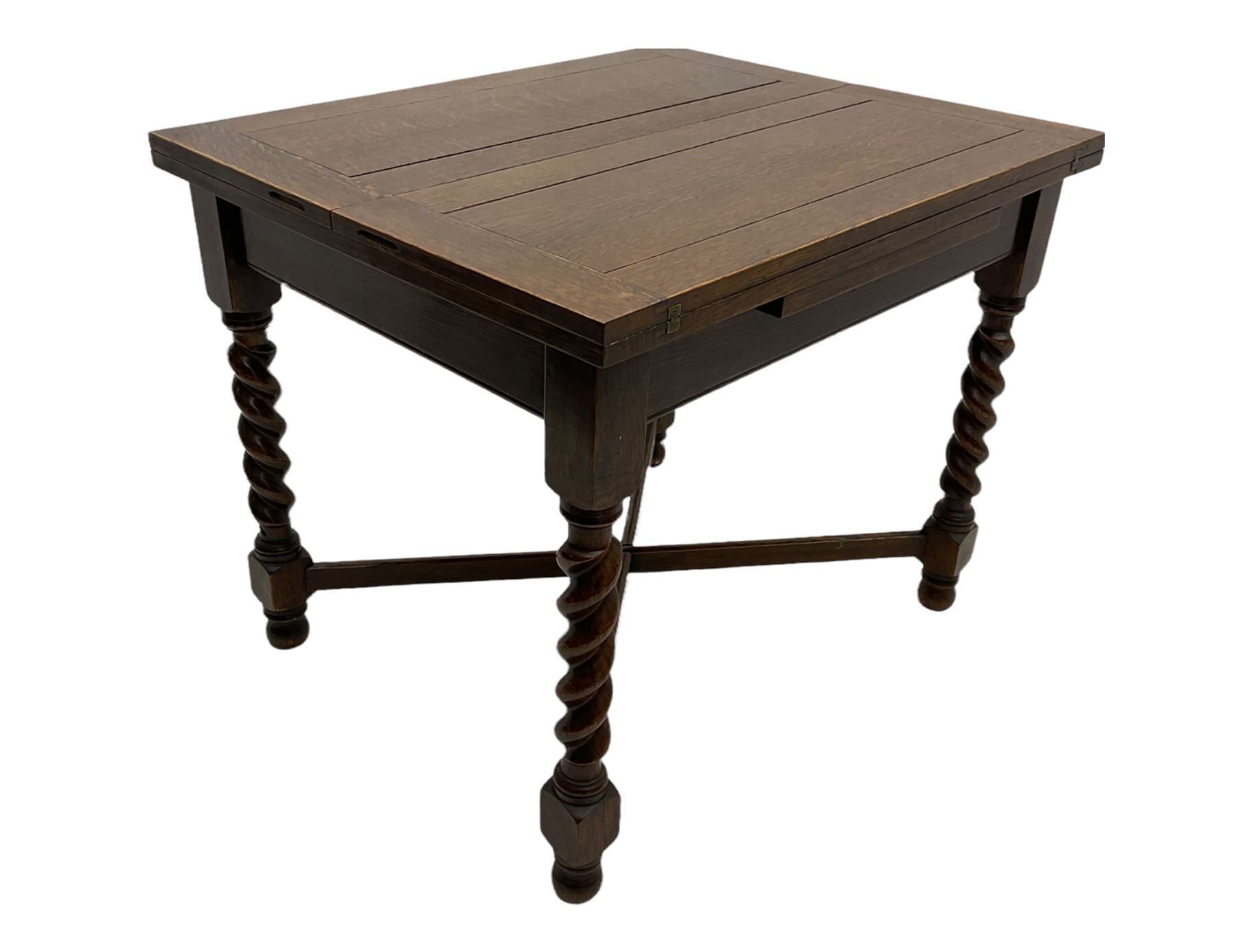 Early 20th century oak barley twist extending table, two fold-over leaves with pull-out stays, spiral turned supports joined by x-stretchers