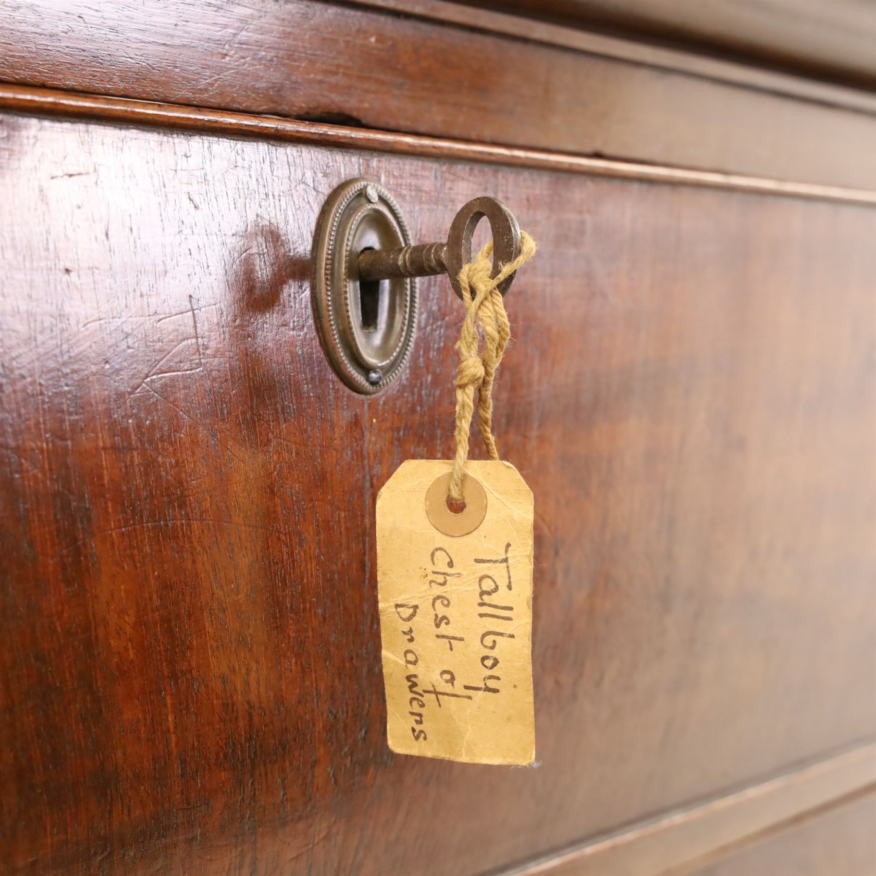 George III mahogany chest on chest, moulded cornice over two short over two long drawers with figured mahogany veneers, lower section fitted with three further long drawers, oval brass plate handles and escutcheons, on shaped bracket feet