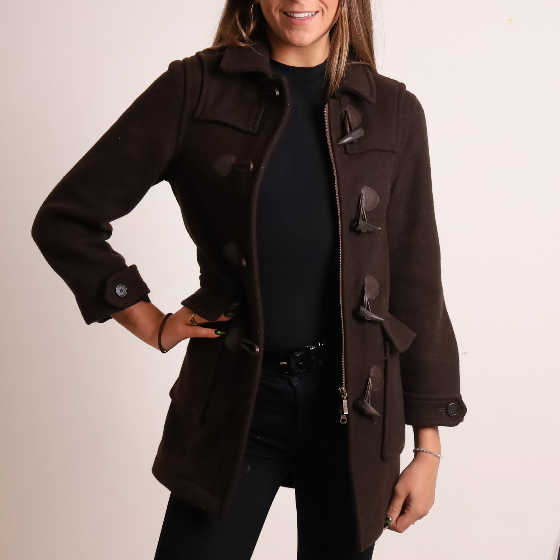 Barbour and Aquascutum - three ladies’ coats, comprising a Barbour Classic Duffle in dark brown wool blend with toggle fastenings and signature tartan lining, size UK 8, together with two Aquascutum herringbone wool coats, each double-breasted and fully lined, both bearing Regent Street London labels (3)