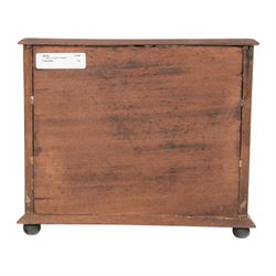 Table top chest of drawers, of rectangular form, with two short and two long drawers, raised upon bun feet, H22cm
