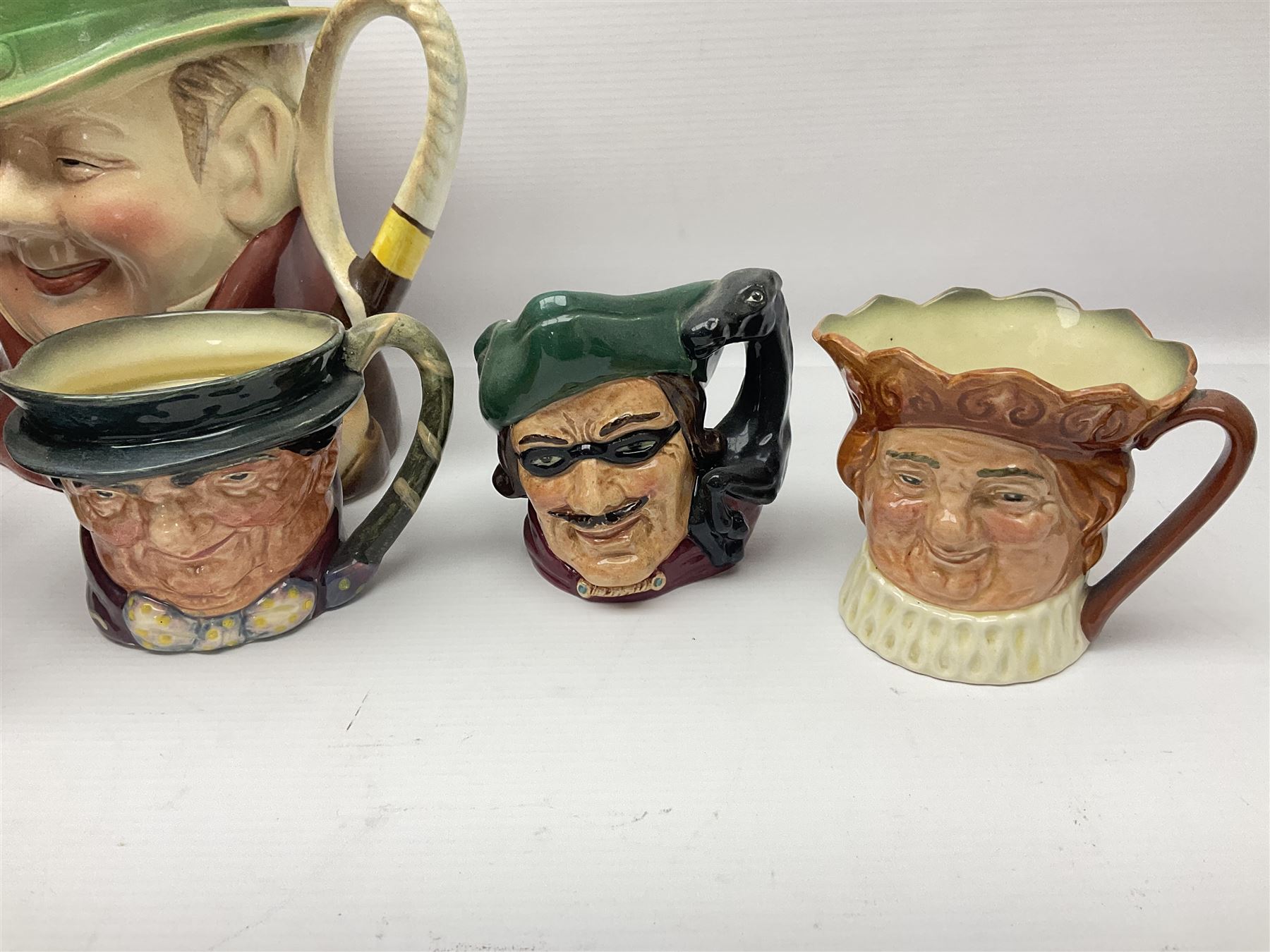 Collection of Royal Doulton and Beswick character jugs of various sizes, including North American Indian D6611, The Falconer D6533,  Tony Weller 281, Sairey Gamp 371 etc