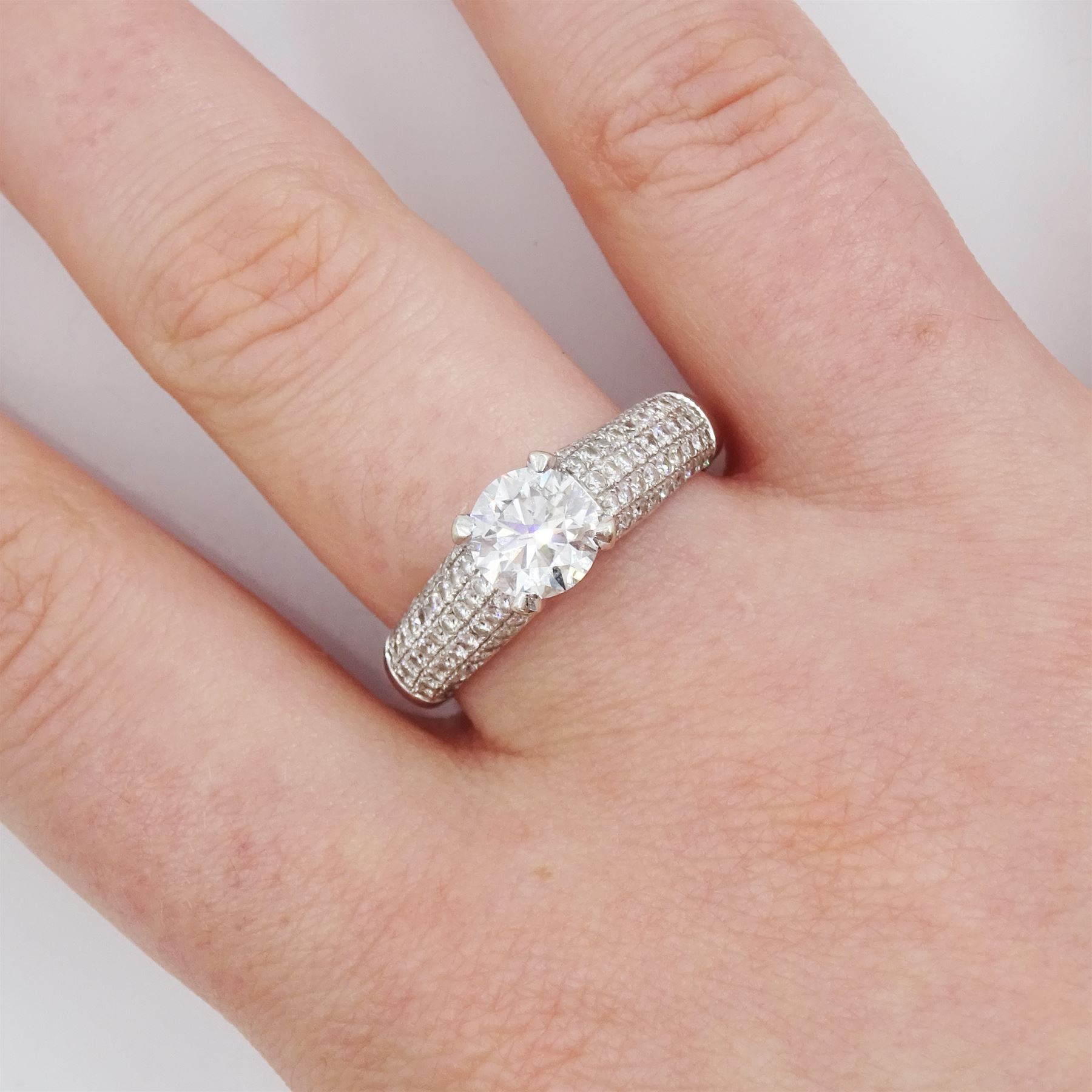 18ct white gold diamond ring, set with a single round brilliant cut diamond of approx 1.10 carat, five row pave set diamond shoulders and gallery, stamped 750, total diamond weight approx 1.50 carat