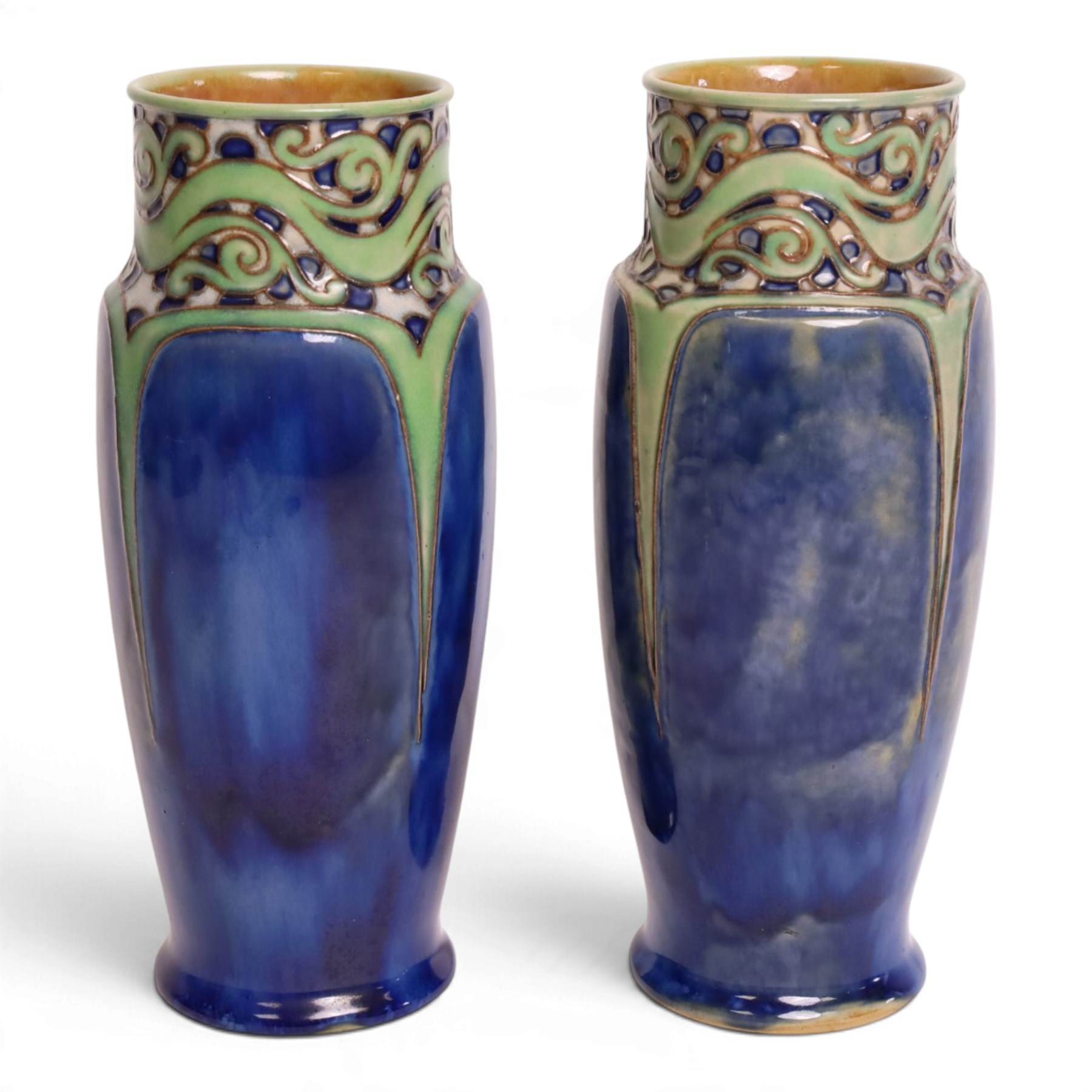 Royal Doulton - Pair of Art Nouveau vases, designed by Francis Pope, with scroll work to the collar, in tones of green and blue, with impressed mark and no. 8138 beneath, H26cm