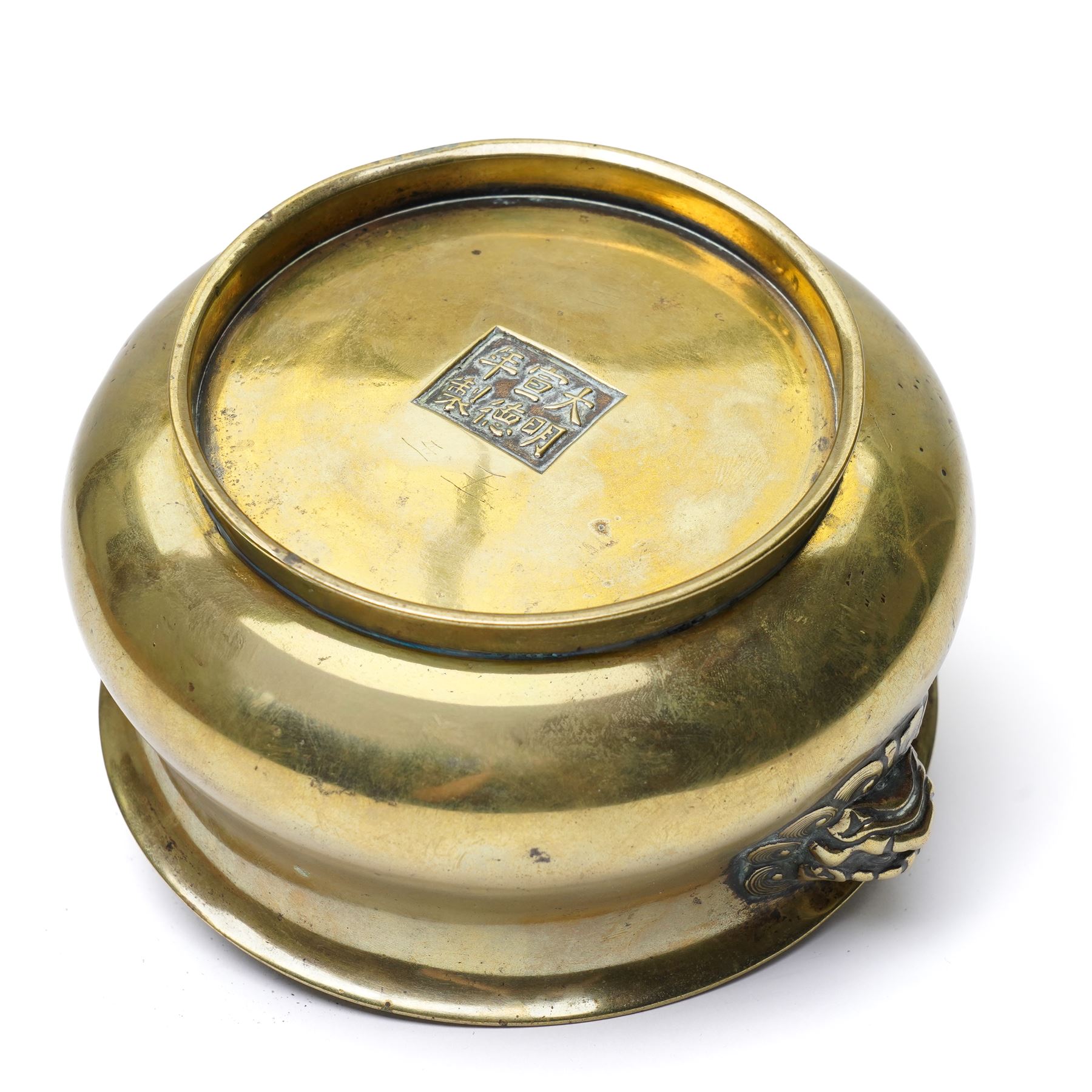 Chinese Ming dynasty gilt bronze censer, of circular bellied form with temple lion mask handles, upon a circular foot, six character Xuande mark to base, D15.5cm