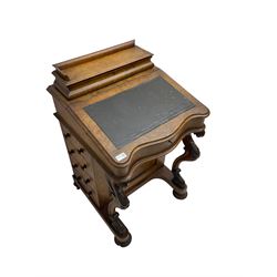Victorian walnut davenport desk, raised compartment over sloped hinged top with leather inset, fitted with four drawers, on serpentine front supports carved with scrolls and foliage, on turned fitted with castors