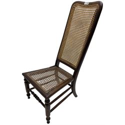 Early 19th century stained beech and mahogany child's correction chair, cane seat and back raised on turned supports united by stretchers