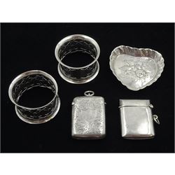Victorian silver heart shaped pin dish with embossed cherub decoration by Henry Matthews, Chester 1898, two silver vesta cases by William Henry Sparrow and 	Minshull & Latimer, Birmingham and two silver napkin rings hallmarked, approx 3oz (5)