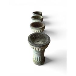 Four 20th century good quality weathered cast stone pedestal urns, circular lobed bowls with rope twist and lattice border, raised on squat base with fluted columns