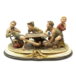 A large Capodimonte figure group, 'The Card Cheat', modelled as four card players, signed Merli, raised upon wooden base, L56cm.
