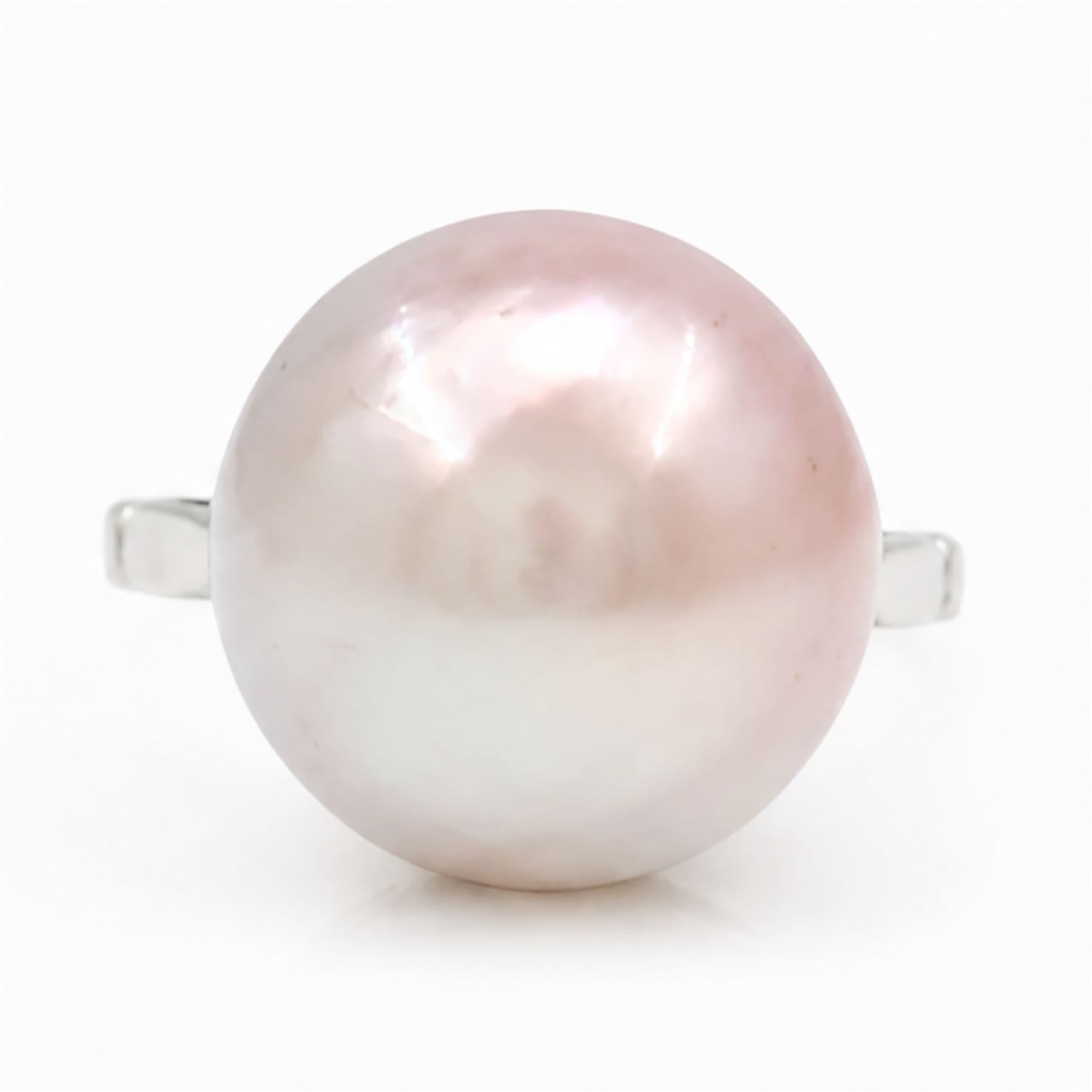 Early 20th century 18ct white gold pink mabe pearl ring, with pierced design floral and scroll gallery