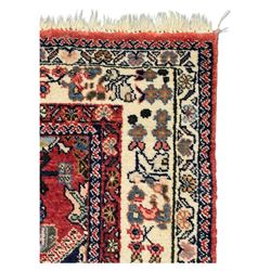 Pair of rugs one Persian hamadan rug central stepped medallion enclosing geometric motifs in ivory and brown, framed by a cream border with scrolling palmettes and fringed ends (H 156cm W 105cm), one Pakistani Bokhara rug rust red ground with repeated Tekke gul motifs within rosette and lozenged borders, fringed ends (H 98cm, W 65cm)