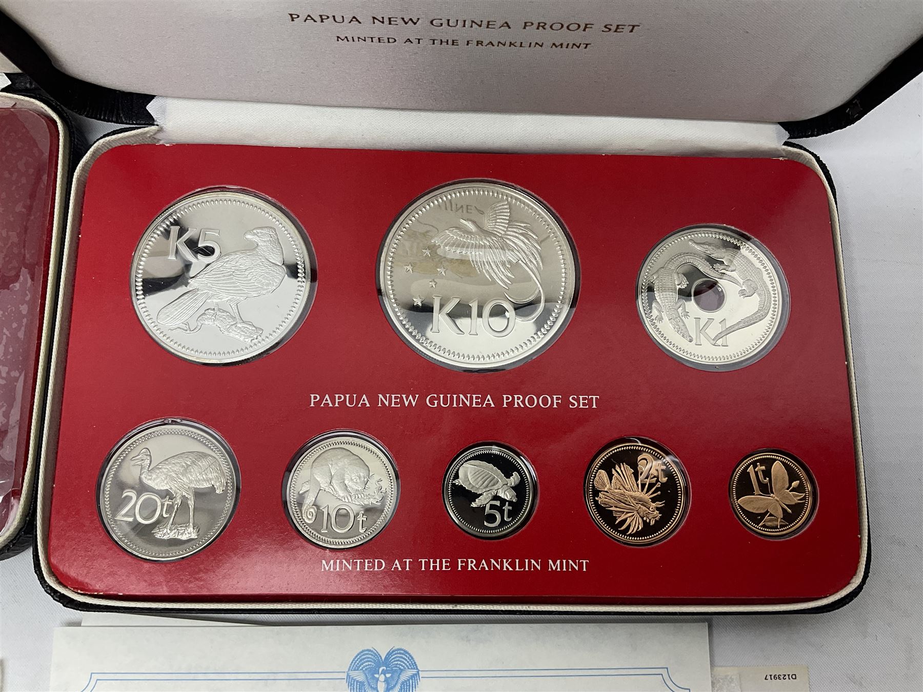 Four Papua New Guinea proof eight coin sets, from ten kina to one toea, comprising First Coinage of Papua New Guinea 1975 proof set, 1976, 1977, and 1979 proof sets, the 1977 and 1979 sets containing 925 silver ten kina and 500 silver five kina coins, all minted at the Franklin Mint, cased with certificates (4)