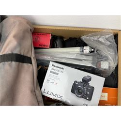 Large quantity of camera equipment in three boxes - Lumix GX1 camera, Canon EOS 500 camera, Lumix FZ100 camera, Pantax  MZ5n, various other cameras, Swift spotting Scope 20 x 60 in box,  Maxtor hard drive, three tripods, Kodak carousel projector, Pradolux slide projector, a selection of camera bags and other camera equipment. 
