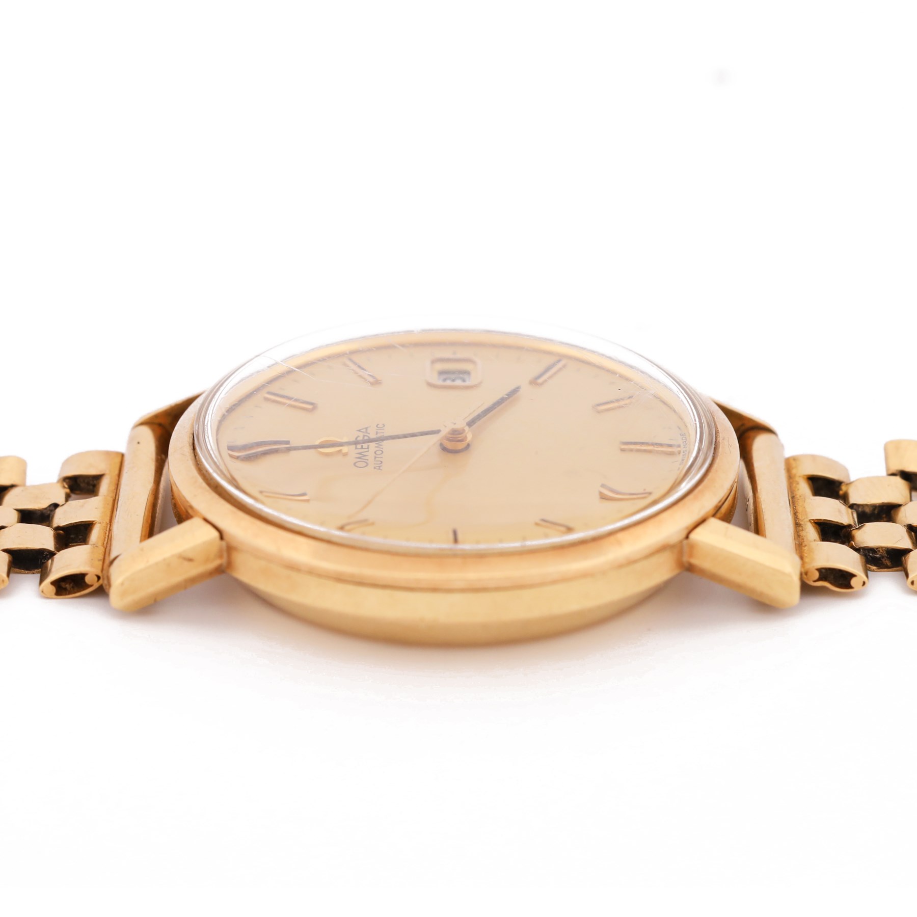 Omega gentleman's 9ct gold automatic wristwatch, gilt dial with baton hour markers and date aperture, back case engraved Tool 106, on a 9ct gold brick link bracelet, London 1976
