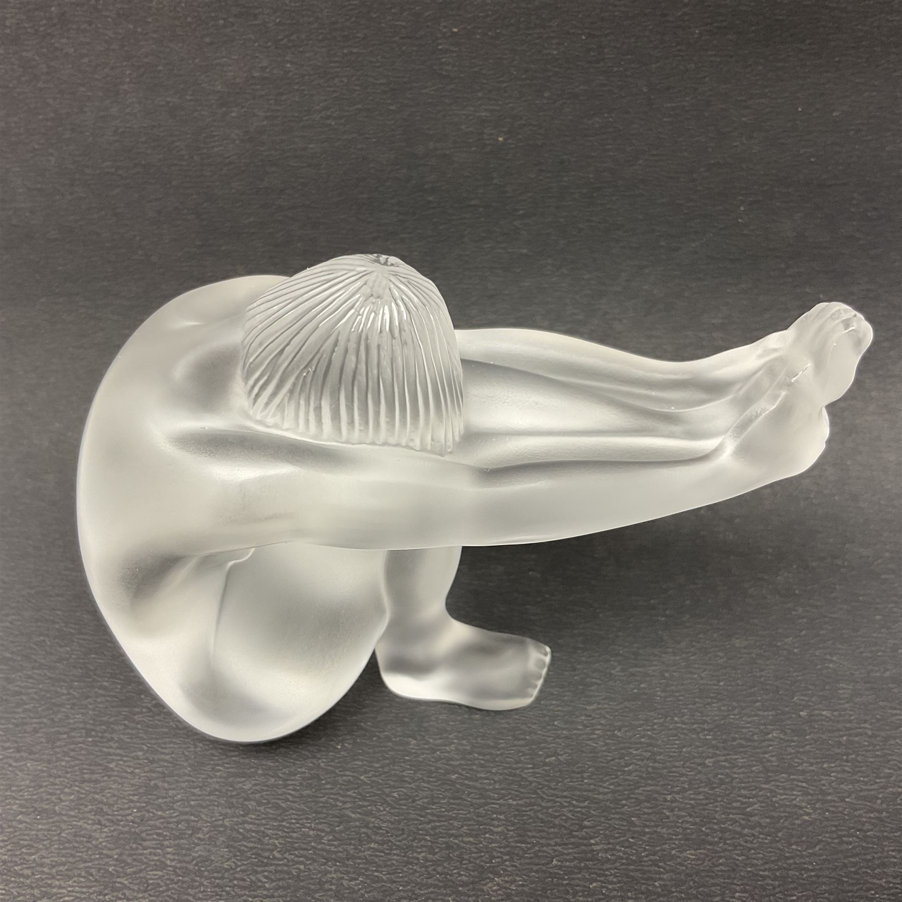 Lalique Nude Temptation, a frosted glass figure of a woman crouching with leg outstretched, in original box, H8cm