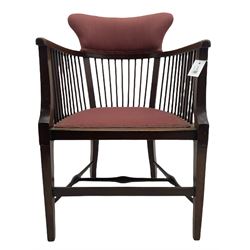 Early 20th century mahogany framed armchair, the raised upholstered back supported by spindles, upholstered seat, square tapering supports joined by swell turned H stretchers and an early to mid 20th century walnut bergère bedroom chair, upholstered seat and back, turned front supports joined by curved stretchers 