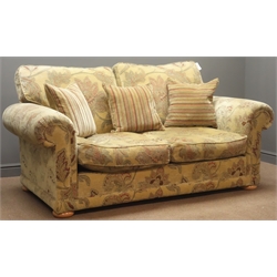  Two seat sofa, (W200cm, D107cm) matching armchair, (W109cm, D96cm) and footstool, upholstered in beige fabric, floral pattern, with scatter cushions  