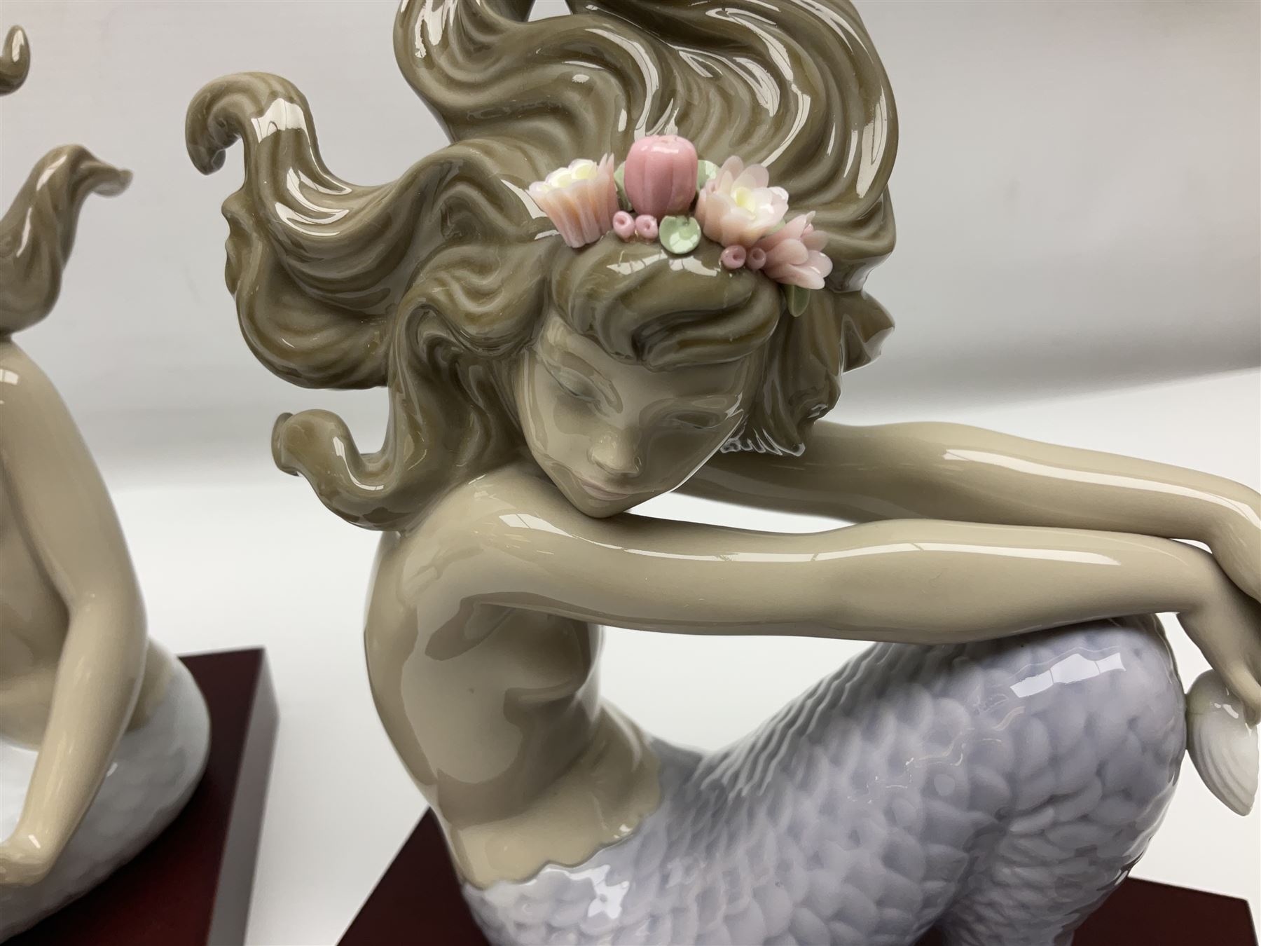 Lladro Mermaid trio set, comprising Illusion no. 1413, Fantasy no.1414 and Mirage no. 1415, all with wooden bases, largest H20cm