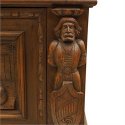 Carved oak coffer bench, rectangular moulded top above carved fall front, with figural, mask and foliate decoration, panelled sides, raised on turned bun feet with shaped lower apron