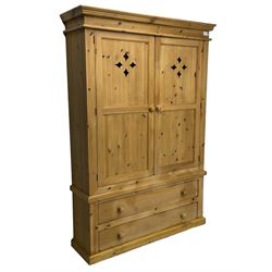 Traditional pine housekeeper's cupboard, two panelled doors with pierced lozenge decoration enclosing three shelves, fitted with two drawers to base